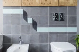 A bathroom with a geometric tile wall