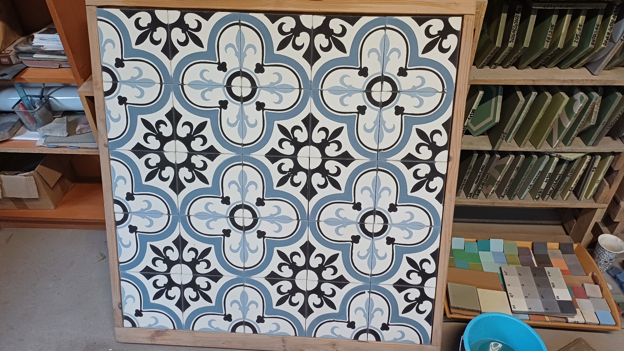 Blue, black and white Purpura tiles arranged in an ornamental composition