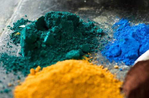 Loose green, blue and yellow pigment powders